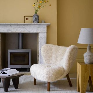 yellow and grey living room with boucle armchair
