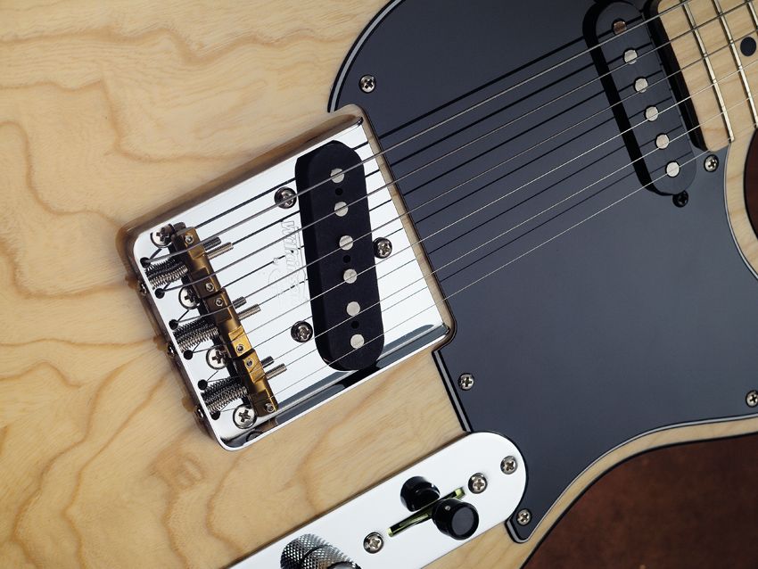 The Wilkinson WTB bridge features compensated brass saddles to improve intonation.