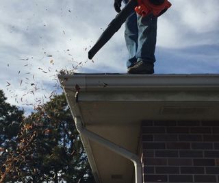 Cleaning gutters with a leaf blower