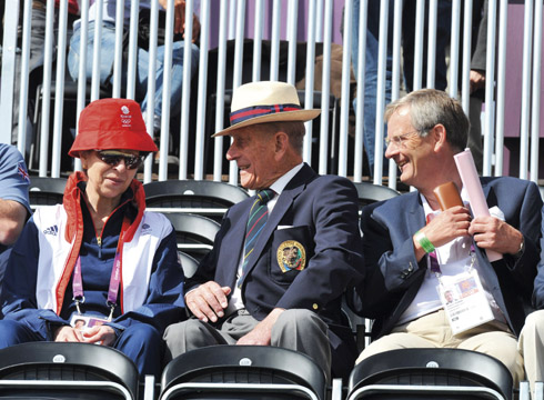 Family first: Prince Philip watches his granddaughter Zara Tindall in action during the eventing dressage at the 2012 London Olympics, with his daughter Princess Anne
