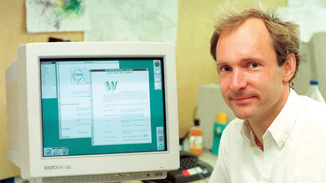 Sir Tim Berners-Lee in front of a computer displaying a website on the World Wide Web.