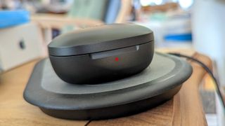 The EarFun Air S powering up on a wireless charging case