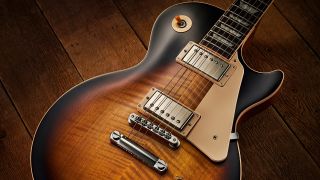 A Gibson Les Paul lying on a wooden floor