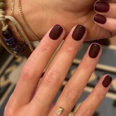 A deep burgundy matte manicure with glossy burgundy French tips