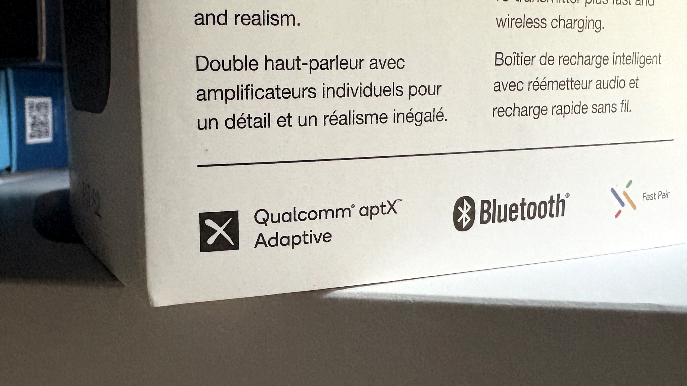 Qualcomm aptX branding, shown on portable hi-fi equipment packaging and a phone screen beside Bowers & Wilkins headphones