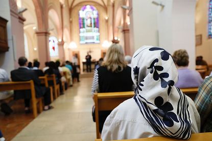 A Muslim woman attends Mass in France