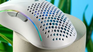 A white Glorious Model D2 wireless gaming mouse with a perforated design