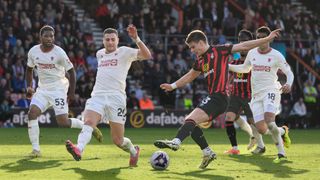 Bournemouth's Milos Kerkez (right) under pressure from Manchester United's Diogo Dalot (left) during the Premier League match between AFC Bournemouth and Manchester United at Vitality Stadium on April 13, 2024 in Bournemouth, England.