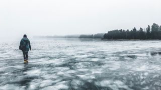 A woman walking on a frozen lake