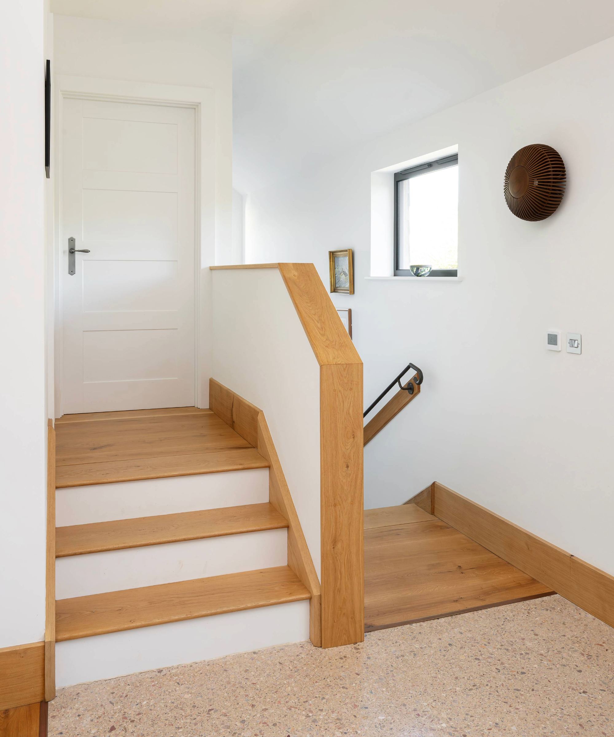 Top of the staircase with a further three steps into a door