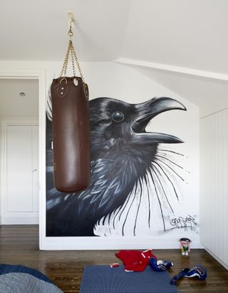 teenage boy bedroom with crow mural and boxing bag