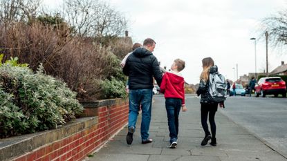 Three children walking down the road
