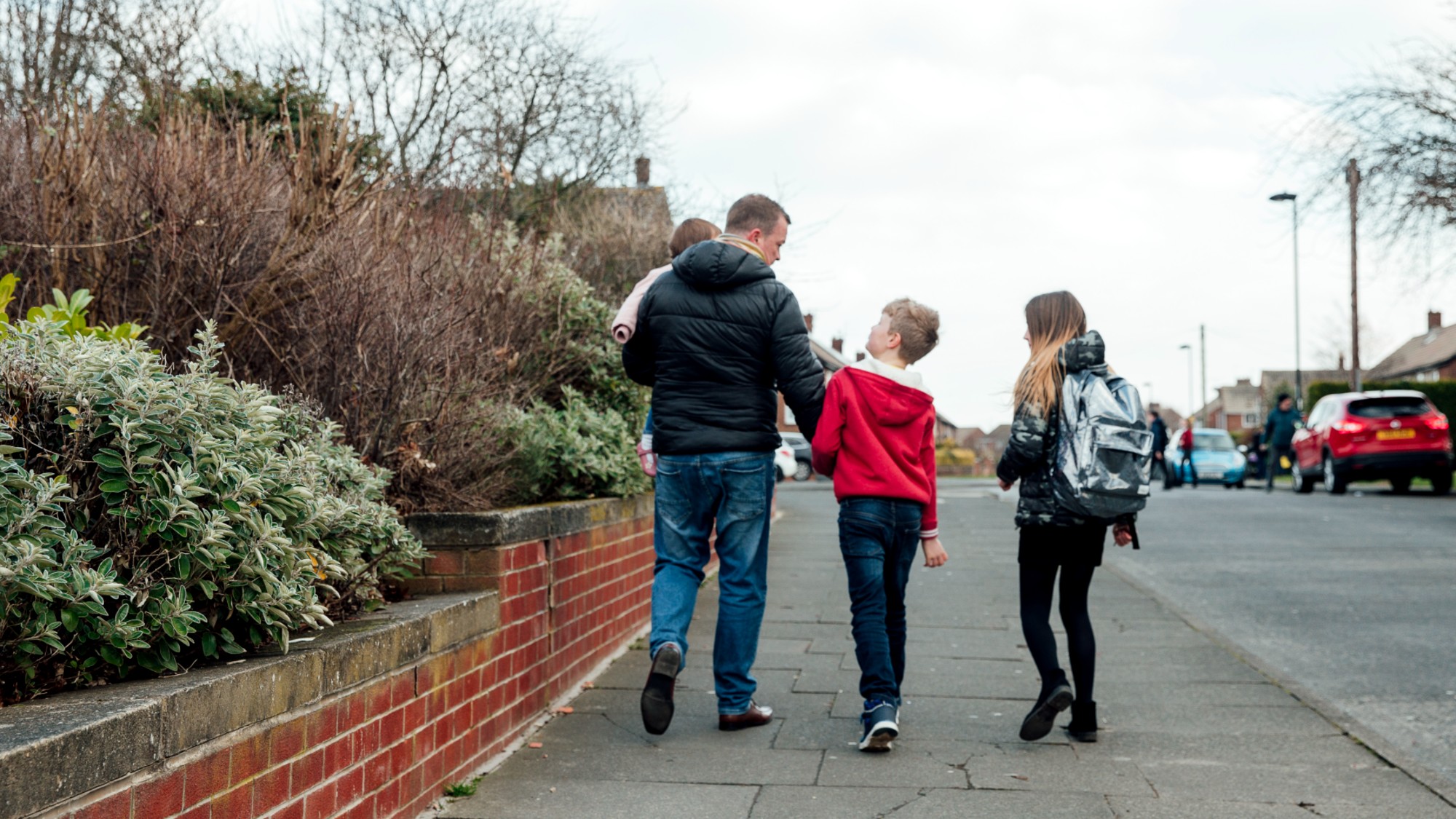 Three children walking down the road