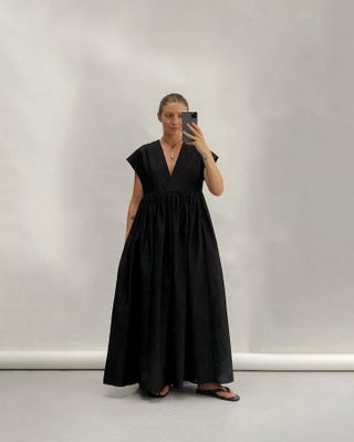 Brittany Bathgate posing in a black dress
