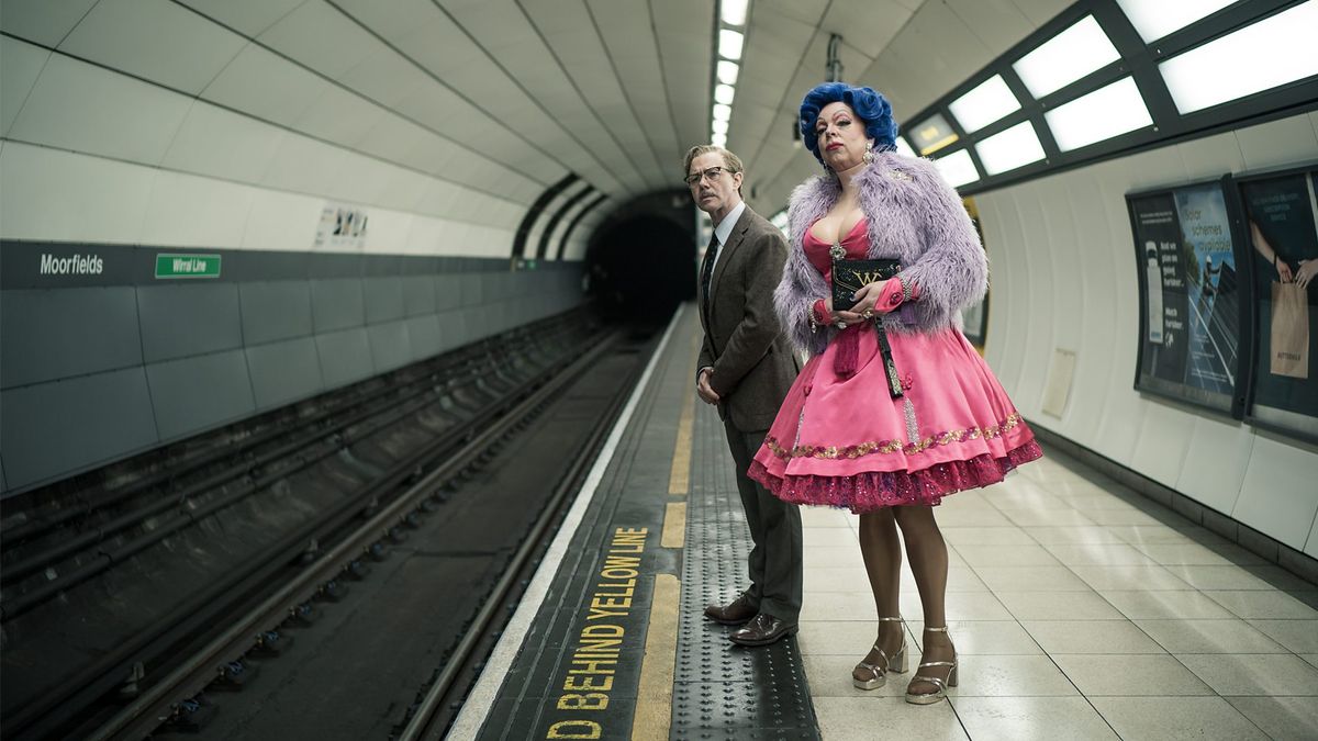 inside No 9 season 9: Reece Shearsmith and Steve Pemberton standing on a train platform. Steve is wearing drag and Reece is in a suit.