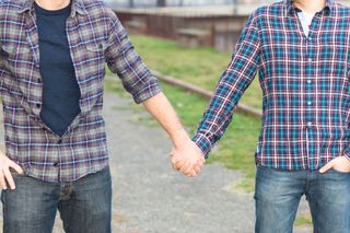 Gay men holding hands.
