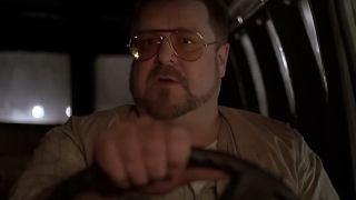 John Goodman driving and wearing sunglasses in The Big Lebowski