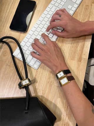 A photo of hands on a keyboard showcasing three Heaven Mayhem watches.