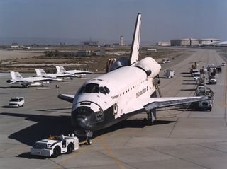 The space shuttle Endeavour is towed off the runway after landing.