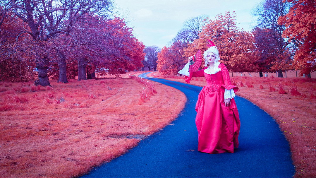 Full-length portrait of a woman in period costume, with an Aerochrome effect