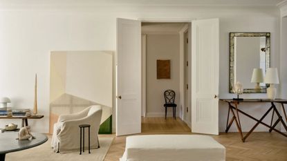 New York City living room demonstrating the principle of negative space in interior design using techniques such as slightly-too-small artwork and thoughtful gaps between large-scale furniture