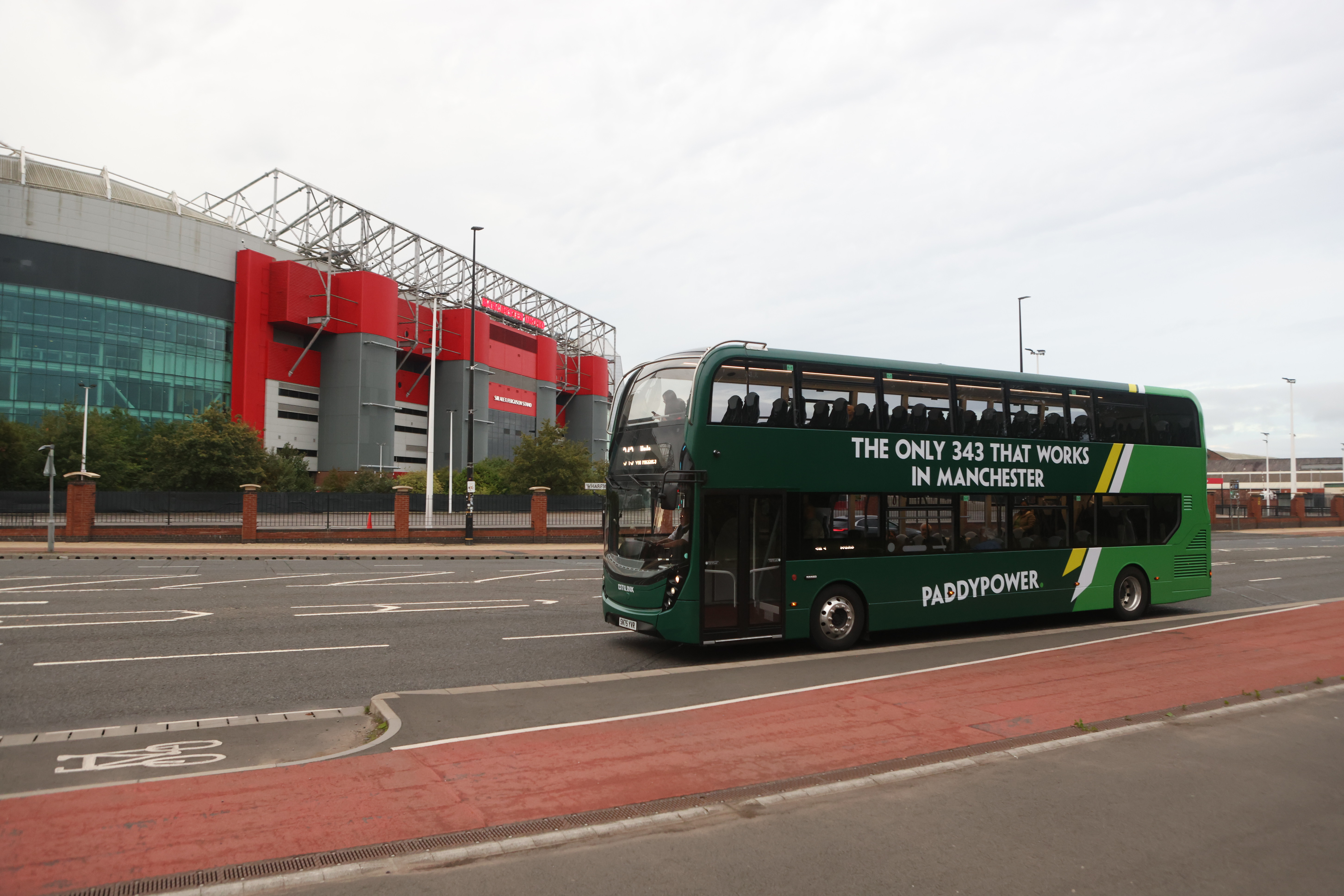 A 343 bus drives past Old Trafford, mocking Ruben Amorim's favoured formation