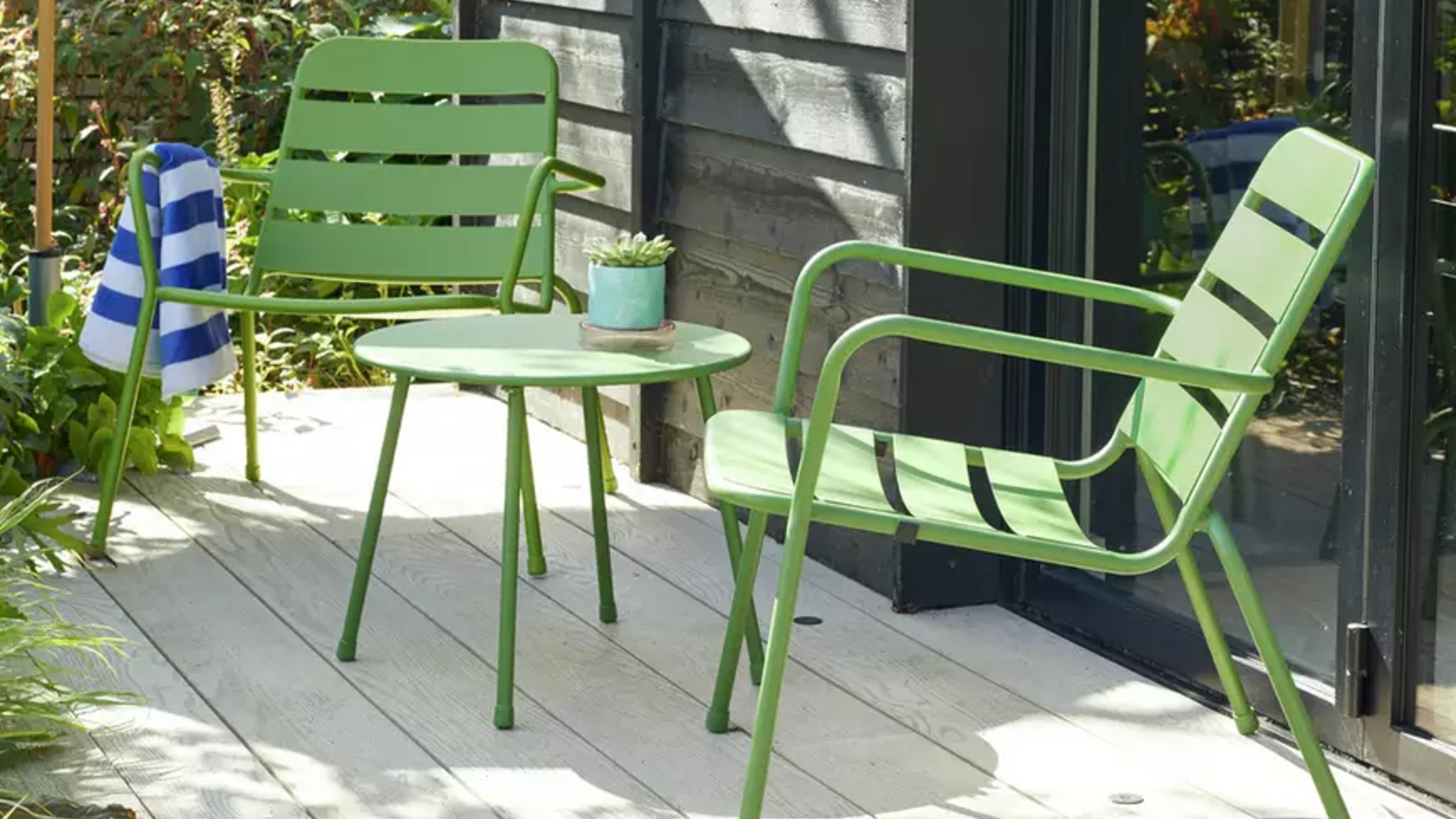 Habitat Annika 2 Seater Metal Garden Bistro Set in green on a patio