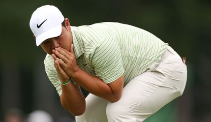 Tom Kim puts his hands to his face after a missed putt