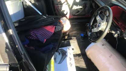 Driver caught behind the wheel of a car with no front seats