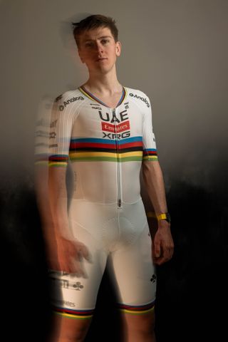 Tadej Pogačar in his UAE Team Emirates 2025 kit, which is plain white, save for the rainbow bands