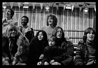 Back row: Pete Townshend, Rocky Dijon, Roger Daltrey. Front row: Brian Jones, Yoko Ono, Sean Lennon, John Lennon, Eric Clapton. Rock And Roll Circus, Intertel Studios, Wembley, December 11, 1968