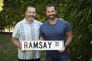 Daniel MacPherson and Ryan Moloney with a Ramsay Street sign in Neighbours 