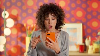Woman using Temu app on smartphone