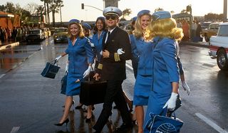 Catch Me If You Can Leonardo DiCaprio flanked by flight attendants in the street