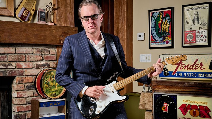 Joe Bonamassa poses at his Nerdville home and museum with a 1955 Fender Stratocaster formerly owned by Howard Reed that was the first Strat with a factory black custom color finish.