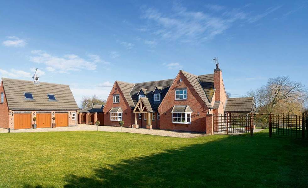 A large, steeply gabled family home with impressively low build costs