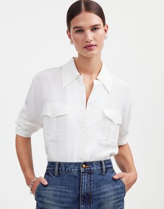 A model wears a white shirt from the alexa chung for madewell collaboration in front of a plain backdrop