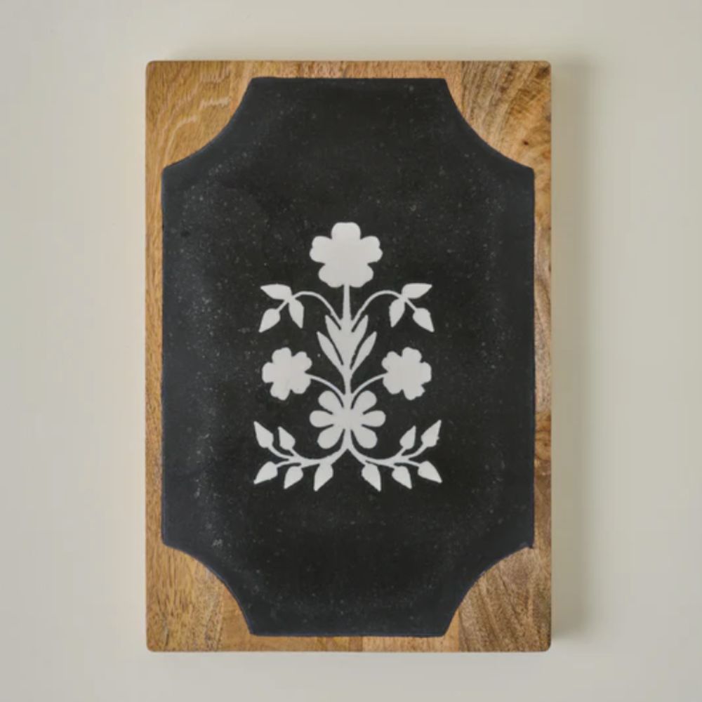 Wooden serving board with black slate and marble floral inlay