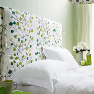 White bed with green headboard