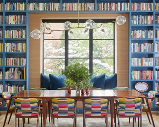 Dining room alternatives, large dining room with bespoke blue book shelving, large wooden dining table