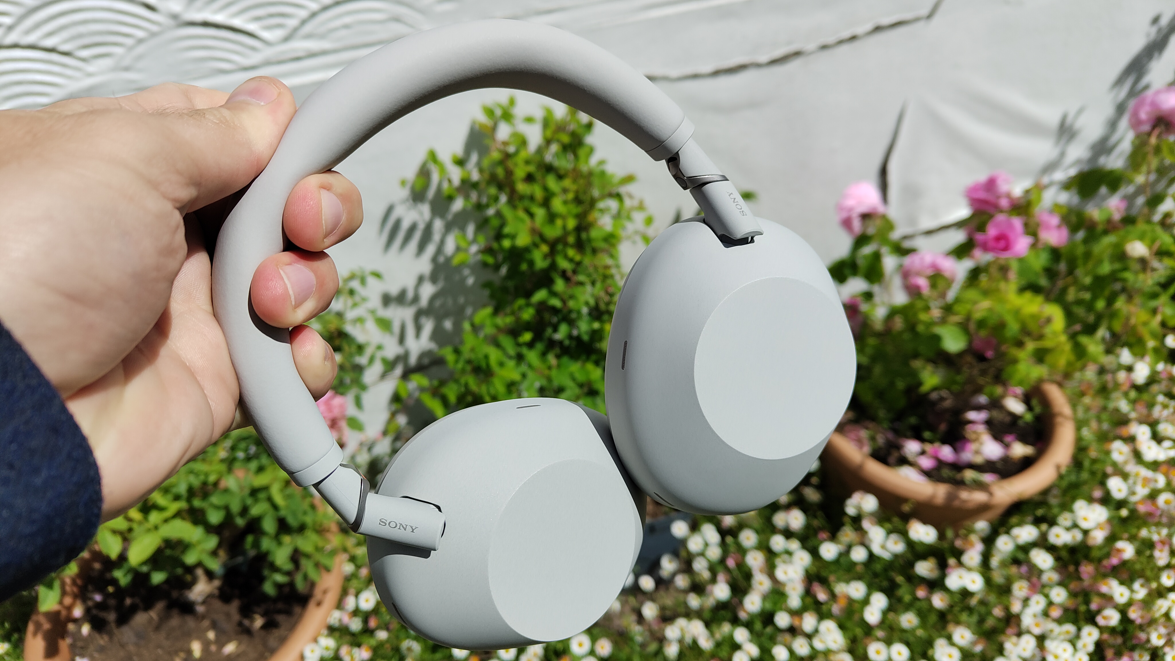 Sony WH-1000XM6 in white held in the hand