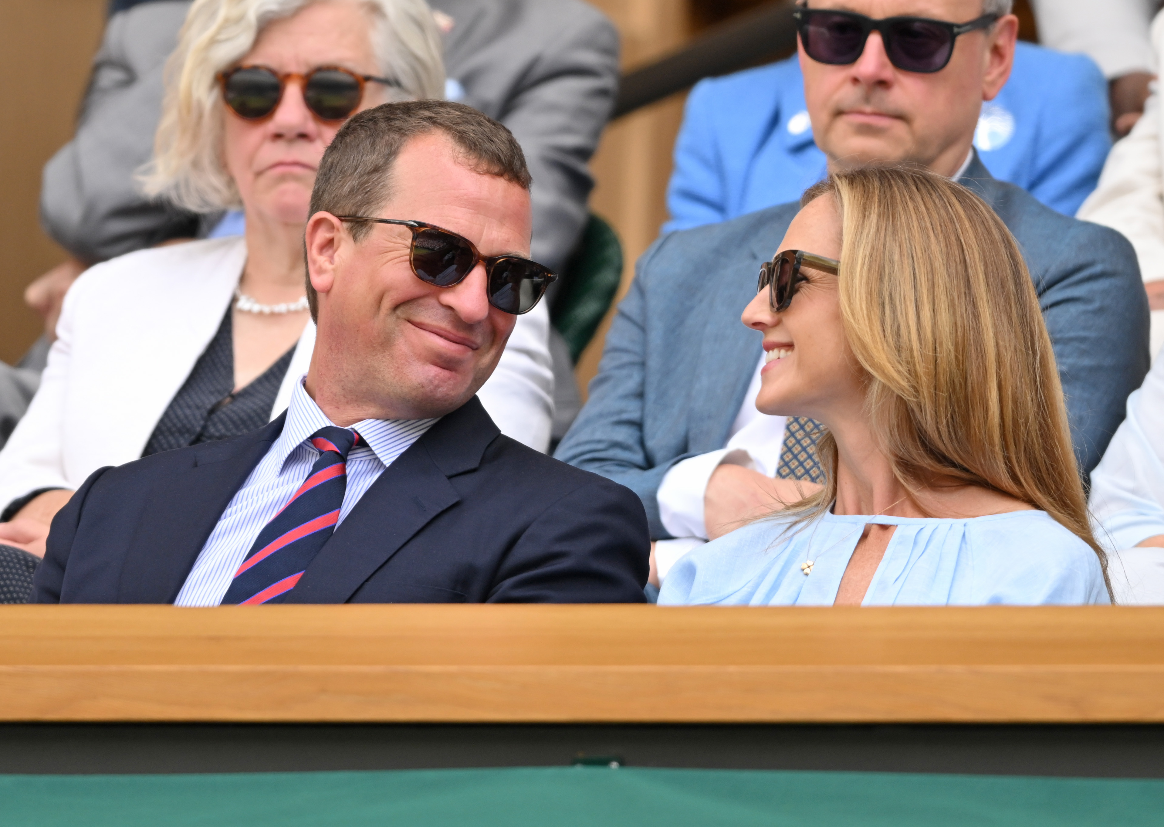 Harriet Sperling and Peter Phillips waring sunglasses smiling at each other