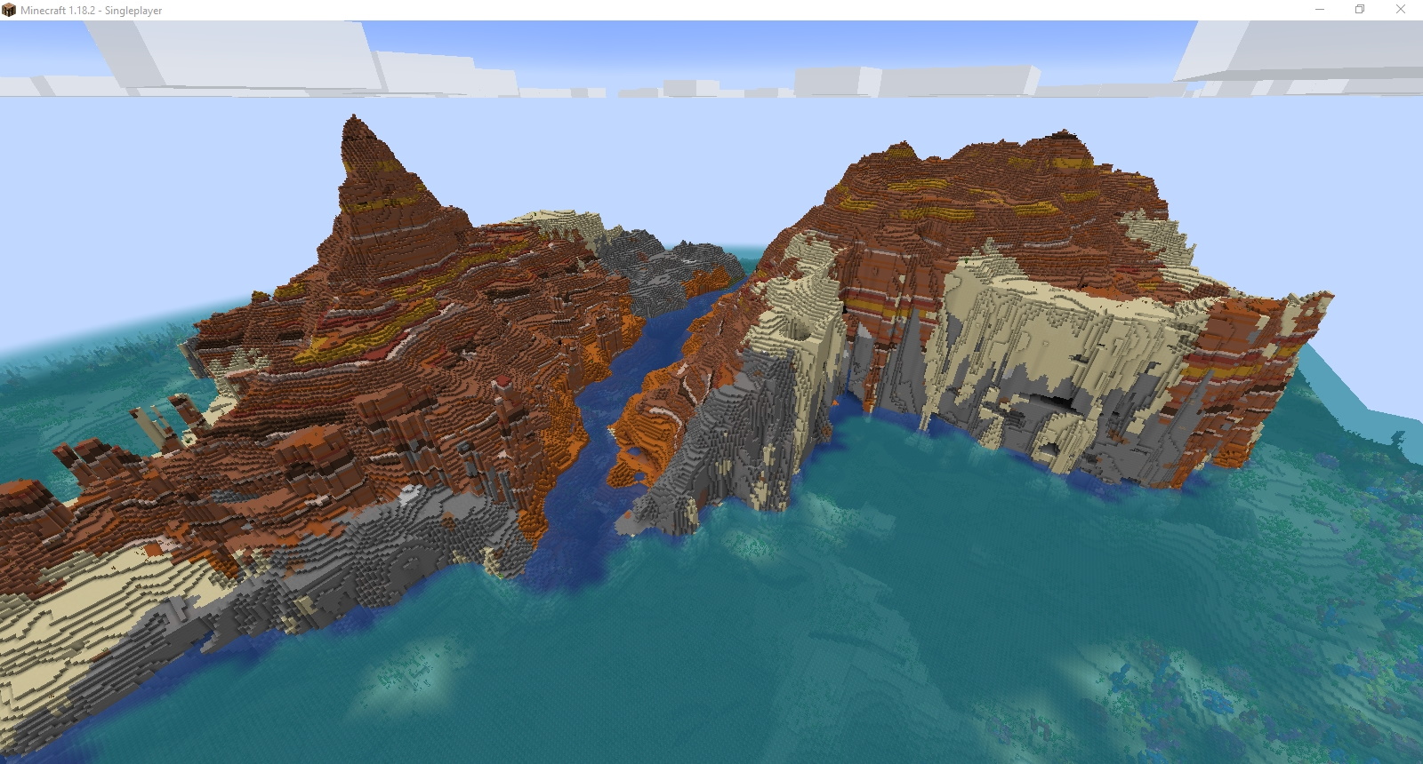 Minecraft seeds - A massive badlands island is bisected by a river