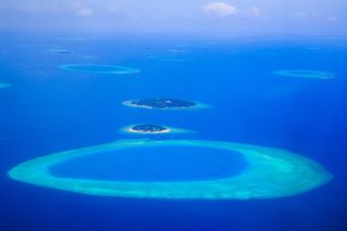 Tropical islands and atolls in Maldives from aerial view. 
