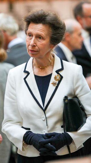 Princess Anne holds her handbag under her arm as she attends an event celebrating 200 years of Henry Poole banking with Coutts, and the book launch of 'Henry Poole & Co: The First Tailor of Savile Row' on September 12, 2019