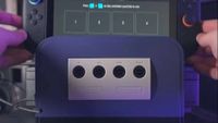 Retro Fighters GameCube Battle Dock with hands lowering Switch 2 onto docking station.