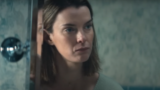 Betty Gilpin looking in the mirror in Three Women