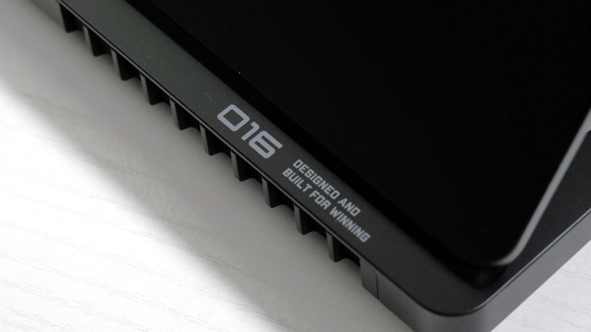HP Omen Max 16 on a white desk, highlighting the 016 logo on the bottom right of the hinge.