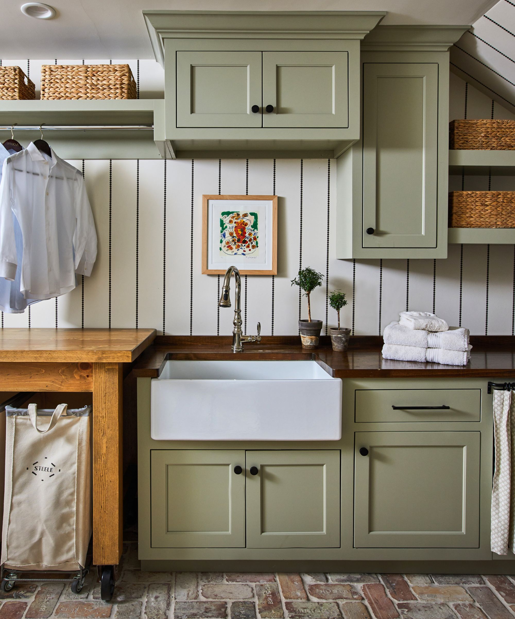 Small country laundry room with sage green cabinets by Whitney McGregor, photograph Laurey Glenn