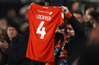 A Luton Town fans holds up a Tom Lockyer shirt during the Hatters' 1-0 win over Newcastle in December 2023, a week after the team captain suffered a cardiac arrest in the Premier League game against Bournemouth.